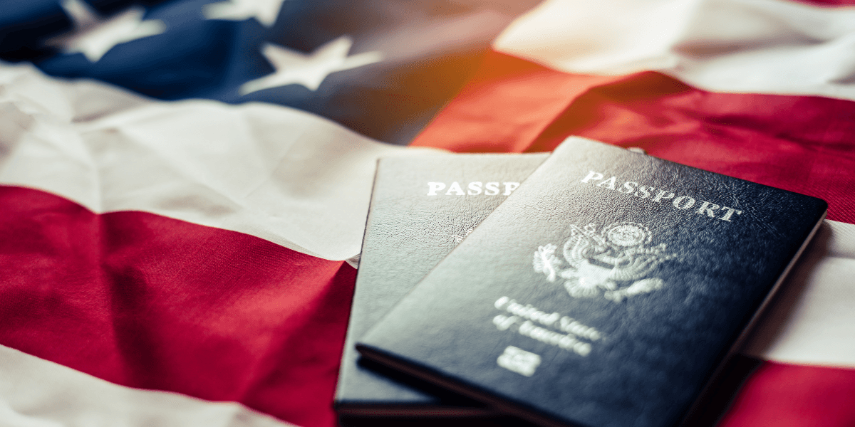 Two U.S. passports on a folded American flag background