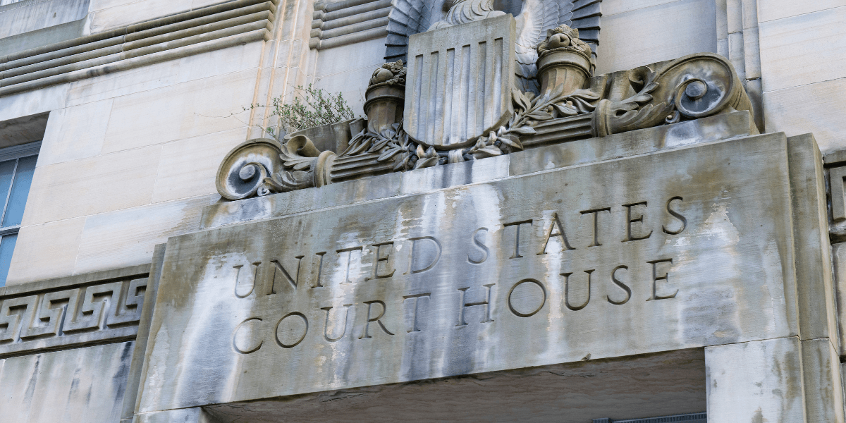 Detail of a United States Courthouse entrance with decorative stonework and an eagle emblem