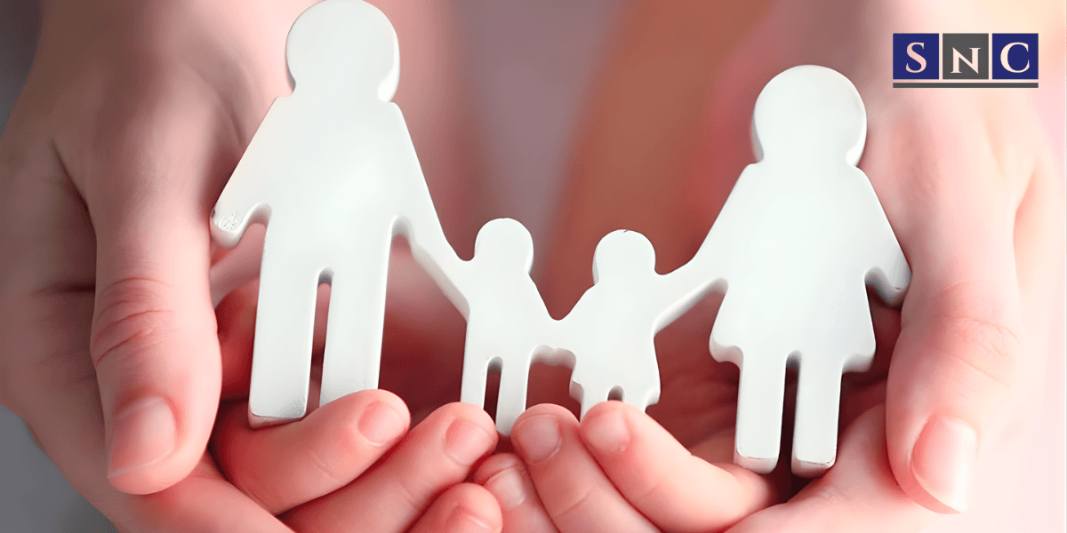 Hands holding paper cutout family figures symbolizing care, unity, and support for legal name change services in California.
