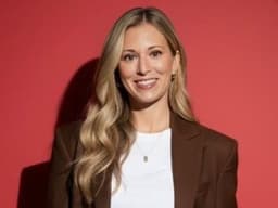 Professional portrait of Jaime Weiland smiling against a red background, highlighting her healthcare education and consulting work.