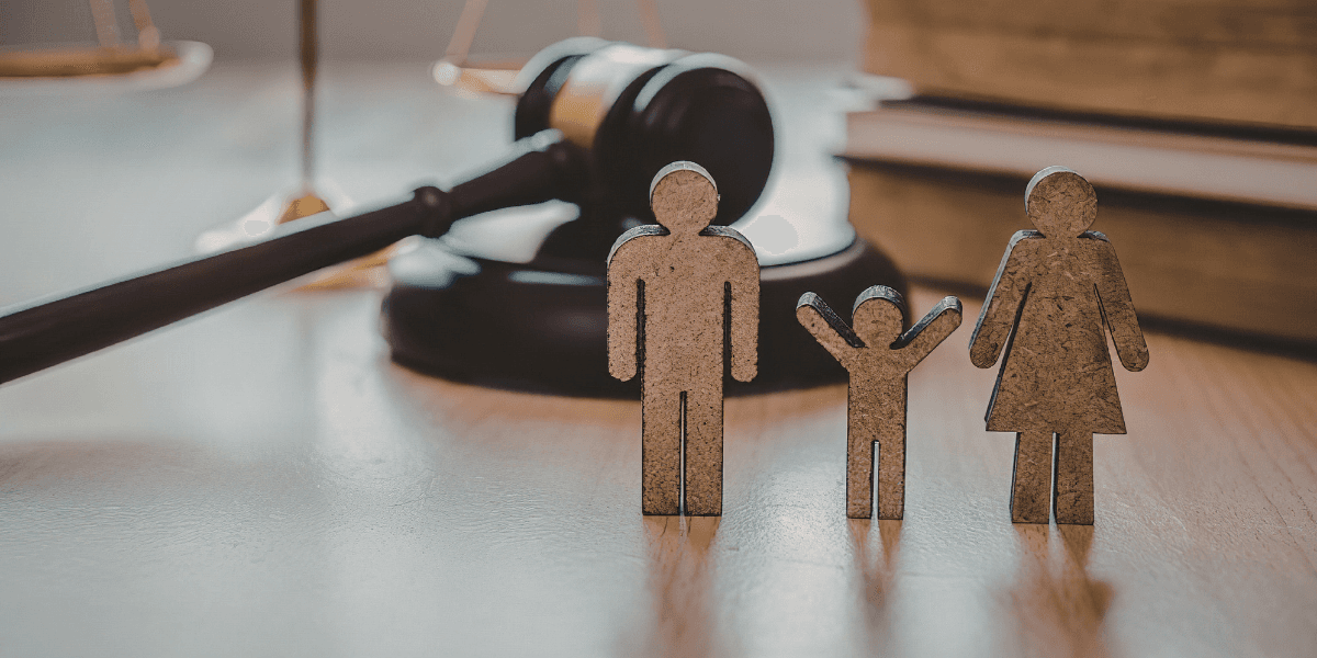 Figures representing a family with a gavel and law books in the background