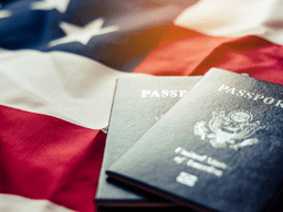 Two U.S. passports on a folded American flag background