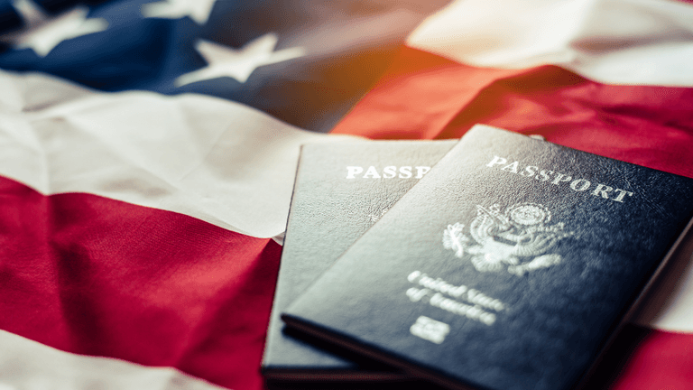 Two U.S. passports on a folded American flag background