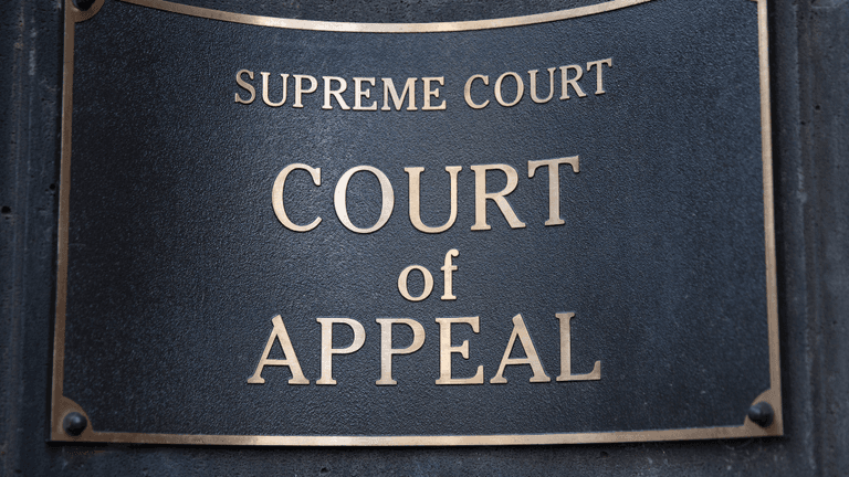 Plaque indicating the Supreme Court of Appeal on a stone wall