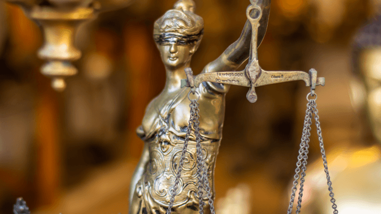 Bronze statue of Lady Justice holding scales, symbolizing law and fairness